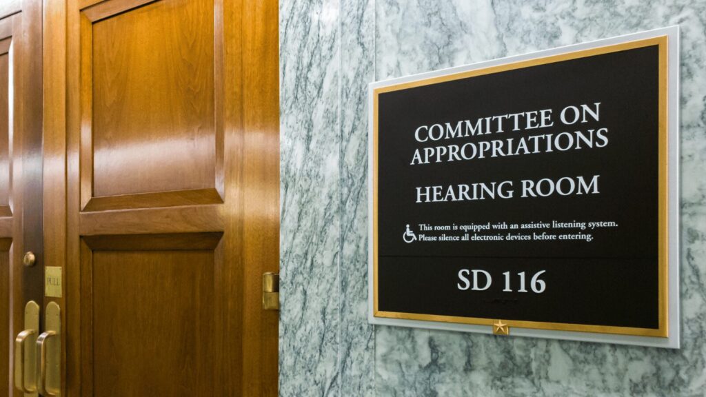 Picture of sign and door of the Committee on Appropriations Hearing Room
