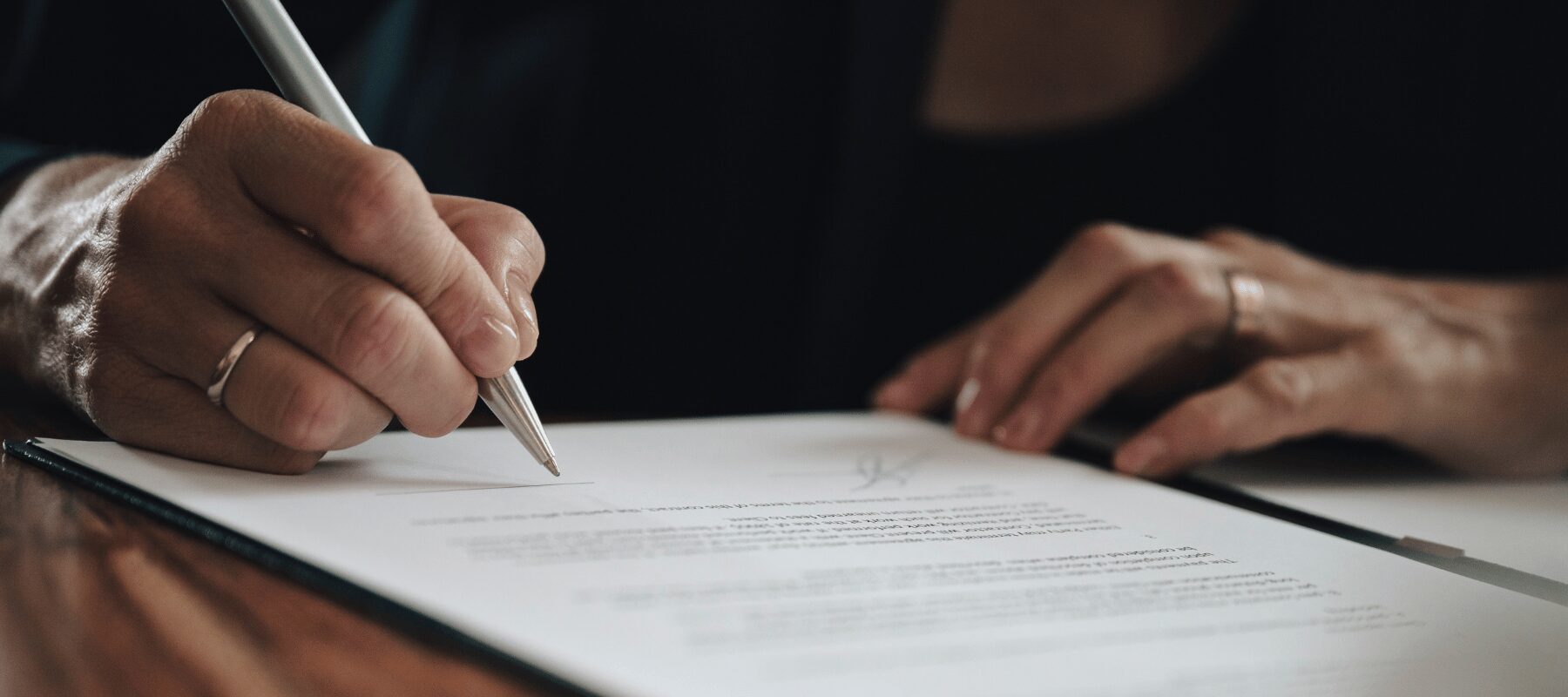 Woman signing a piece of paper