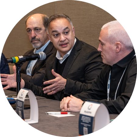 Three public health professionals sitting and talking on a panel