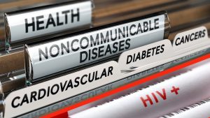 Tabs labeled health noncommunicable diseases cardiovascular diabetes cancers and HIV plus in a filing system drawer