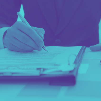 A person writing with pen on paper.