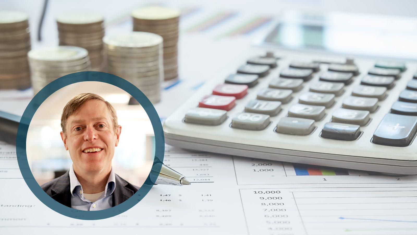 Tim Leshan with calculator and paperwork in background