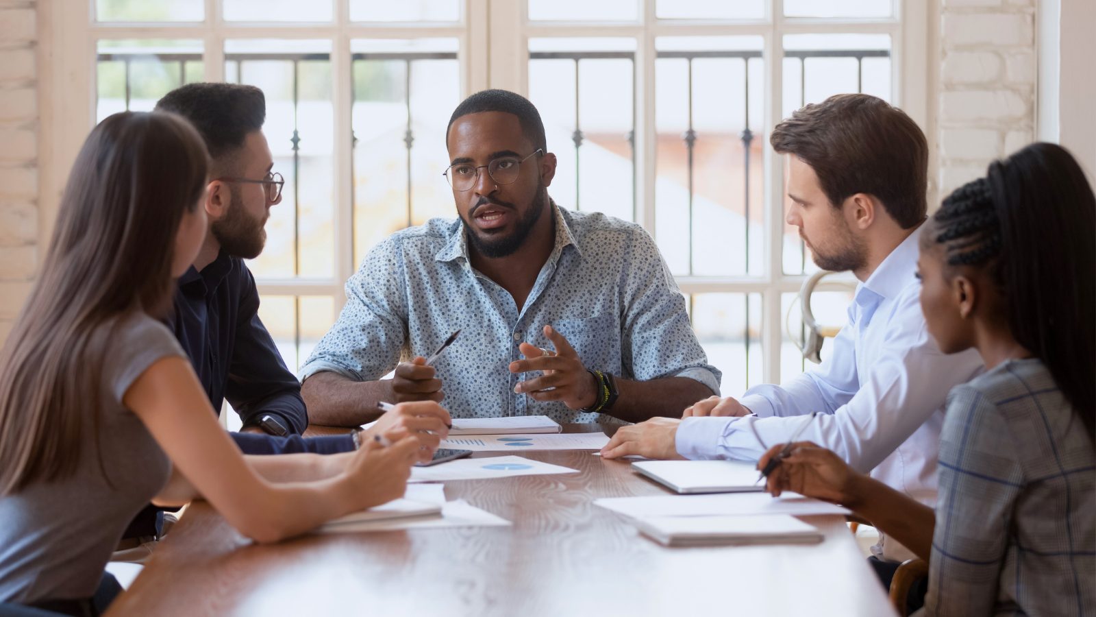 Image of people discussing something in a meeting
