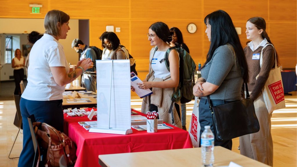 Image of students at a booth at the TIPH Graduate Fair