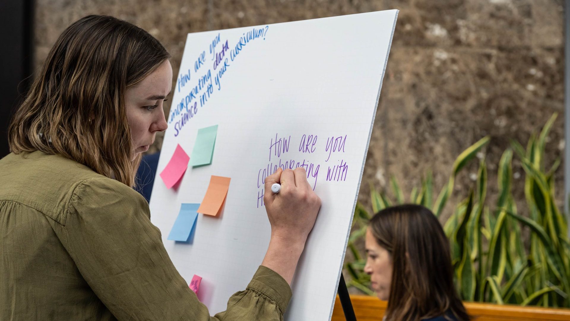 A woman writing on a board