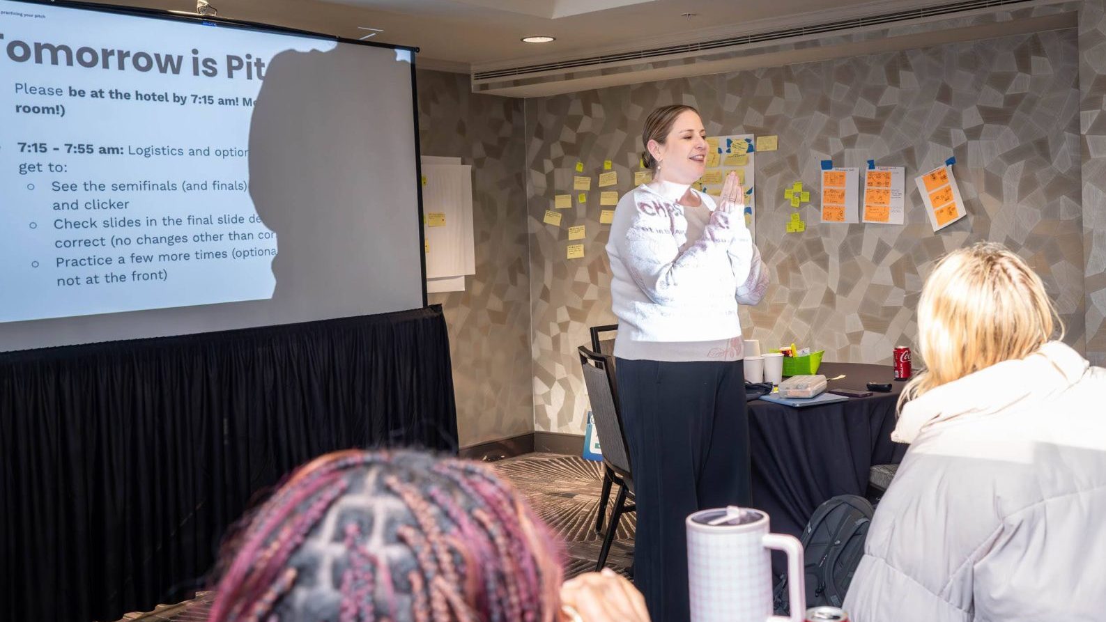 A woman giving a presentation with a projector