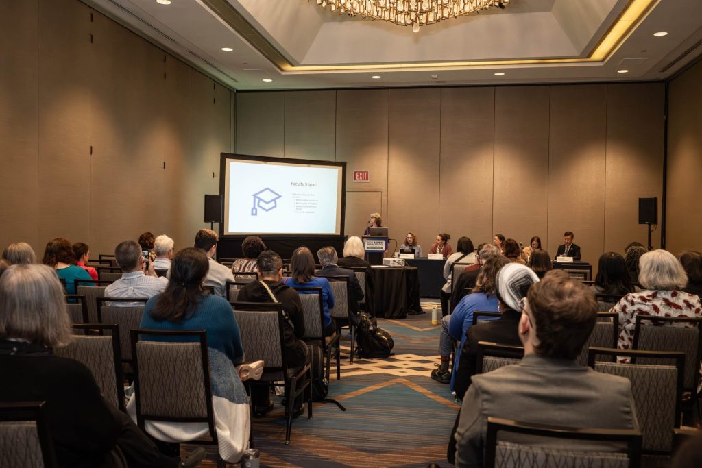 Crowd of people sitting and listening to a panel