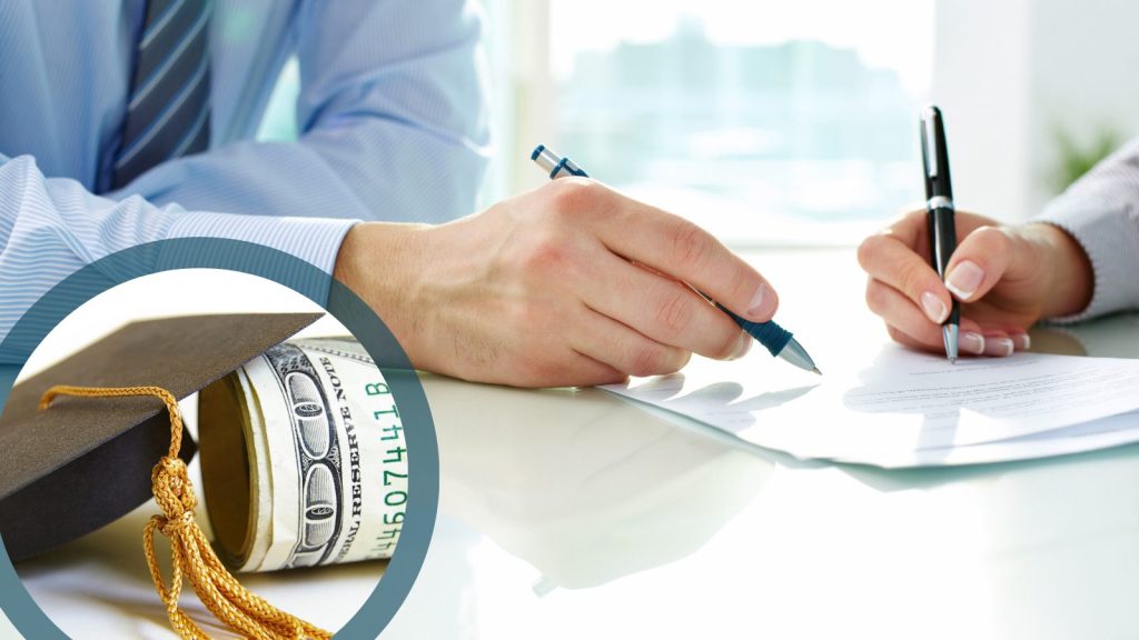 Close up image of two hands signing a document