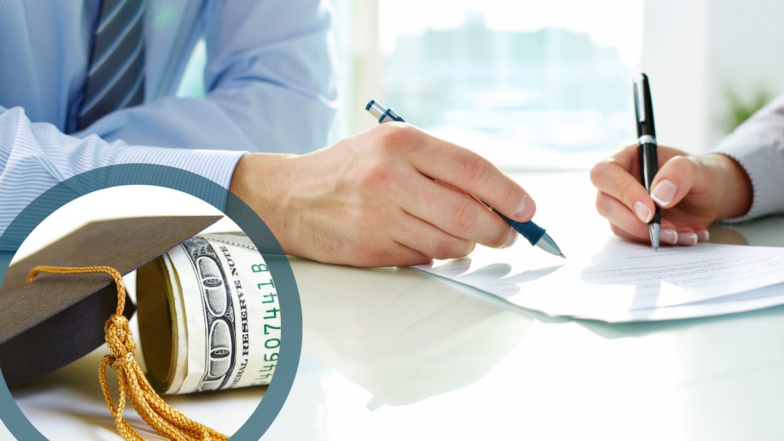 Close up image of two hands signing a document