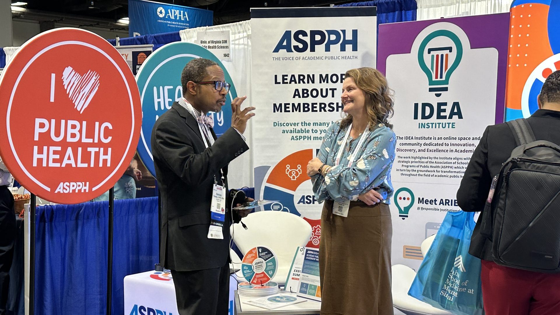Two people talking at an event booth