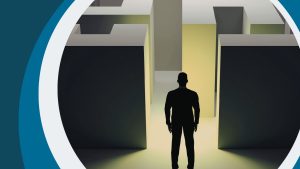 Silhouette of man standing in front of a maze