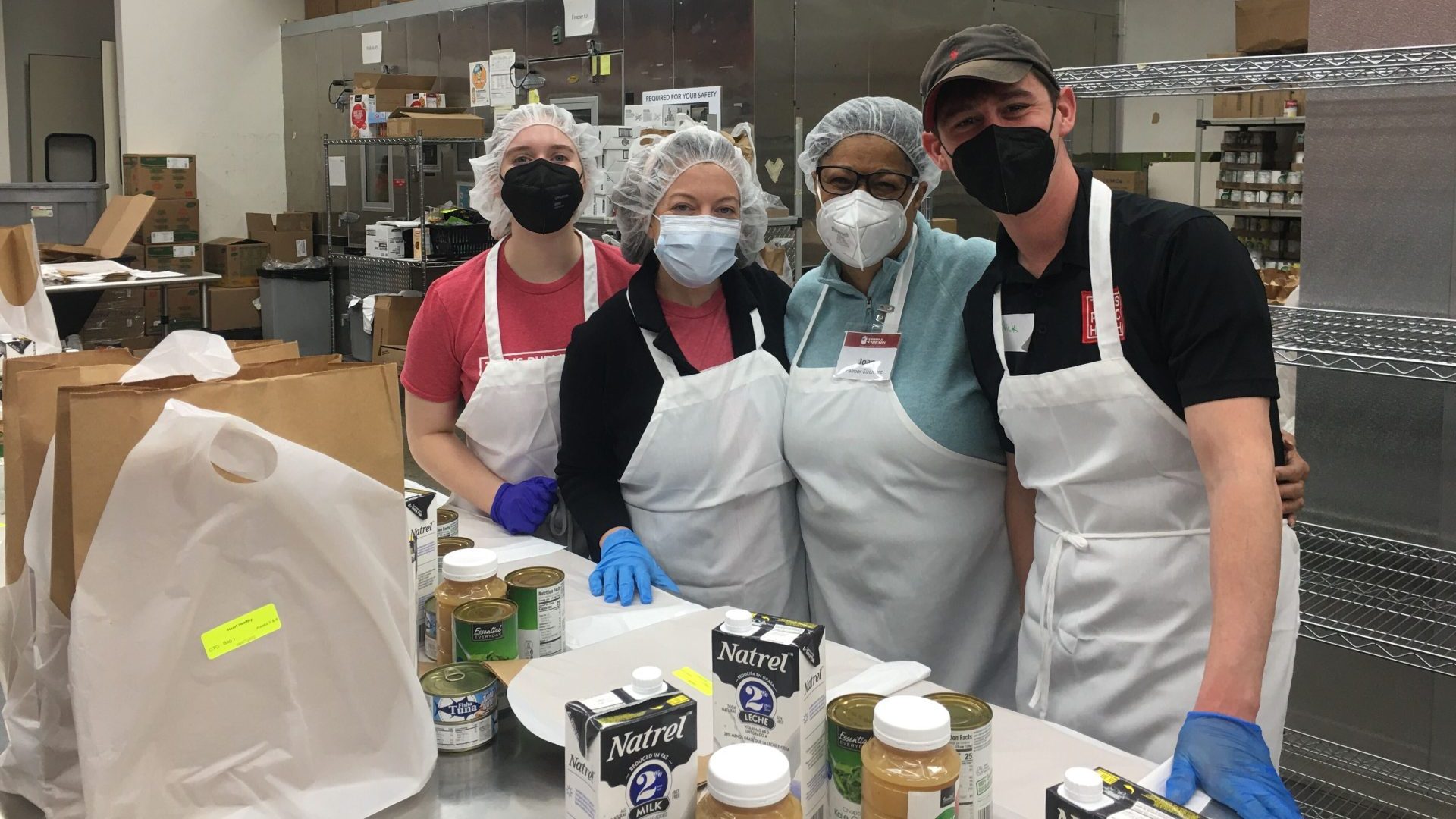 Four people volunteering at food kitchen