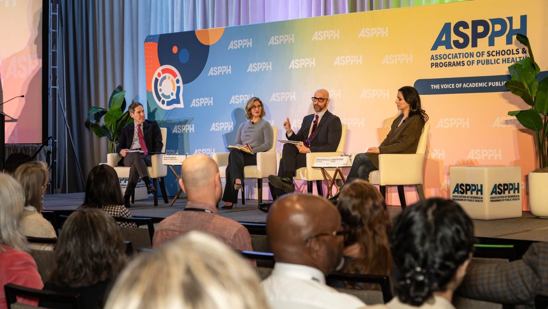 http://A%20four-person%20panel%20having%20a%20discussion%20in%20front%20of%20audience