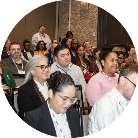 An audience watching a panel speak