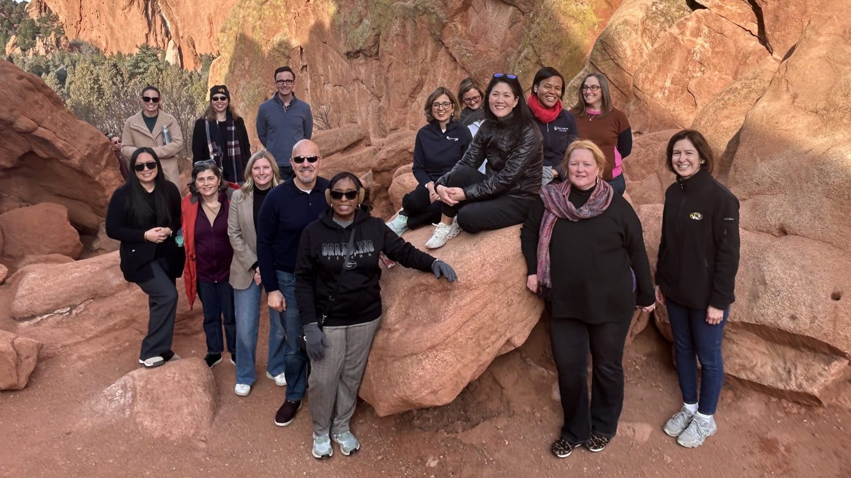 Group of people posing on a rock formation