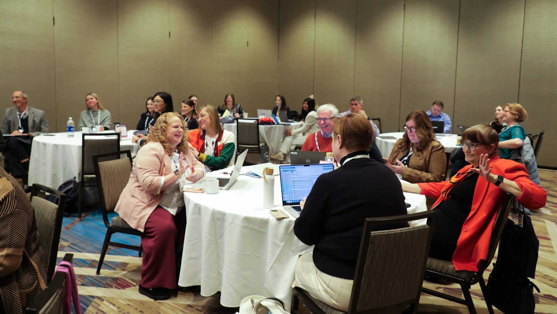 http://Multiple%20tables%20of%20people%20having%20discussions