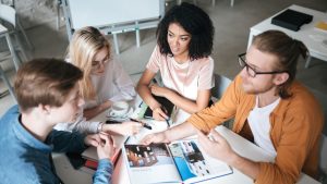 Group of people sitting around a table working on a project