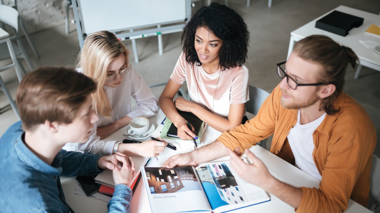 Group of people sitting around a table working on a project