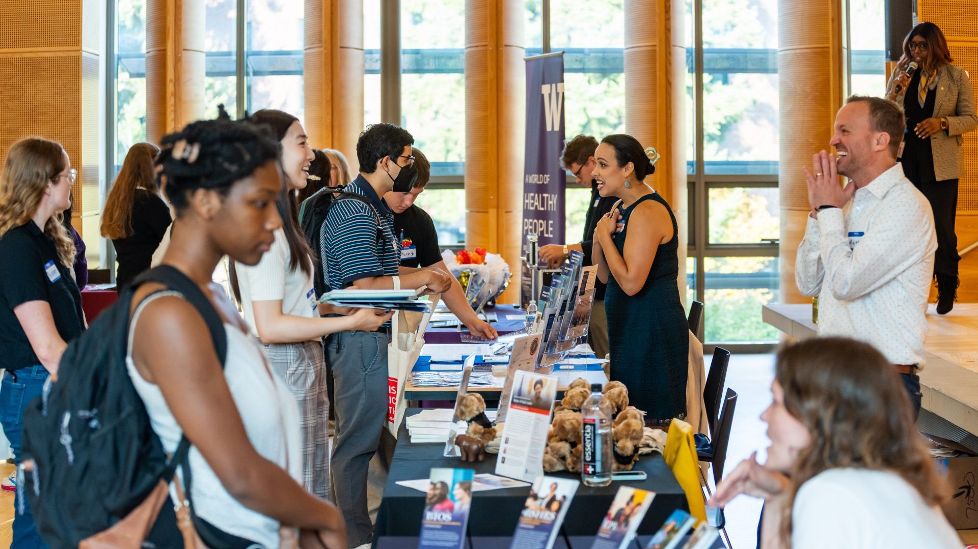 Exhibitors and students at a fair